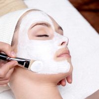 cosmetologist applying skincare treatments at cosmetology school